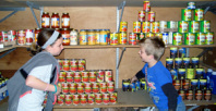 Image of young volunteers stocking shelves