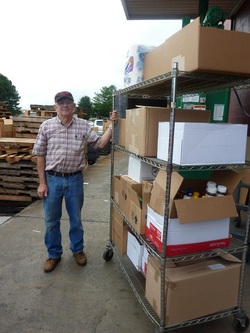 Image of volunteer picking up food supplies for the hungry