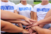 Photo of team of volunteers with stacked hands