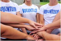Image of volunteer team wiht their hands stacked